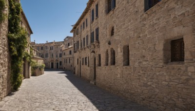 outdoors,sky,day,blue sky,no humans,window,shadow,plant,building,scenery,door,road,wall,street,tree,bush,architecture,house,brick wall,path,town,arch,pavement,stone floor,stone wall