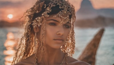 1girl,solo,long hair,looking at viewer,brown hair,black hair,hair ornament,bare shoulders,brown eyes,jewelry,closed mouth,collarbone,outdoors,sky,dark skin,water,blurry,dark-skinned female,lips,depth of field,blurry background,ocean,portrait,sunset,realistic,nose,necklace,eyelashes,veil,mountain,sun,headdress