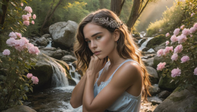 1girl, solo, long hair, looking at viewer, brown hair, hair ornament, dress, upper body, flower, outdoors, hair flower, water, white dress, tree, lips, sunlight, nature, pink flower, forest, rock, realistic, river