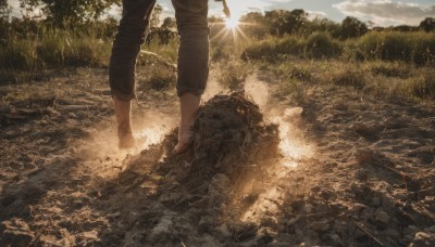 solo,1boy,standing,male focus,outdoors,sky,barefoot,day,pants,cloud,water,tree,sunlight,grass,nature,scenery,lens flare,forest,walking,light rays,rock,realistic,sun,brown pants,dirty,river,landscape,pants rolled up,dirty feet,shirt,long sleeves,white shirt,shoes,cloudy sky,field