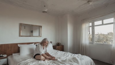 1girl,solo,long hair,shirt,sitting,closed mouth,closed eyes,white shirt,grey hair,shorts,barefoot,day,indoors,pillow,window,bed,bed sheet,on bed,black shorts,curtains,t-shirt,scenery,realistic,clock,lamp,photo (object),bedroom,wide shot,picture frame,blonde hair,brown hair,hood,short shorts,bare legs,looking down,sunlight,blinds