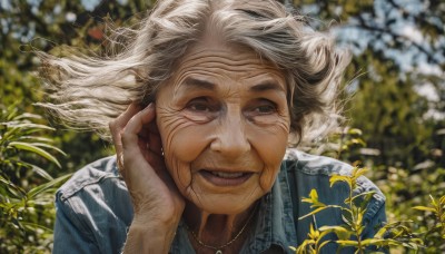 1girl,solo,looking at viewer,smile,short hair,open mouth,shirt,brown eyes,jewelry,jacket,white hair,grey hair,outdoors,day,hand up,necklace,blurry,lips,floating hair,depth of field,blurry background,blue shirt,plant,blue jacket,wind,portrait,hand on own face,realistic,old,old woman,wrinkled skin,denim jacket,teeth,grey eyes,leaf,denim