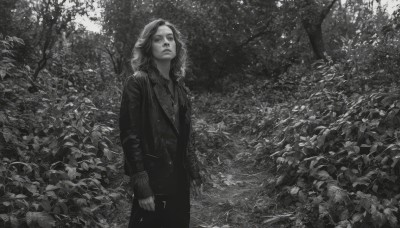 1girl,solo,long hair,shirt,long sleeves,jewelry,closed mouth,standing,jacket,monochrome,greyscale,outdoors,medium hair,necklace,tree,coat,leaf,plant,nature,scenery,forest,realistic,looking at viewer,cowboy shot,open clothes,pants,sleeves past wrists,looking up,arms at sides,bush