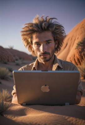 solo,looking at viewer,smile,short hair,brown hair,shirt,1boy,brown eyes,upper body,male focus,outdoors,sky,day,collared shirt,blurry,black eyes,blurry background,facial hair,messy hair,beard,realistic,mustache,computer,laptop,desert,lips,depth of field,stubble,dirty,real life insert,tablet pc,dirty face