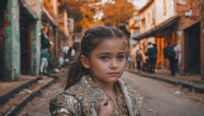 1girl,solo,long hair,looking at viewer,blue eyes,brown hair,black hair,hair ornament,closed mouth,upper body,outdoors,solo focus,armor,blurry,lips,depth of field,blurry background,realistic,nose,road,crowd,people,brown eyes,day,hand on own chest,child,portrait,female child,street