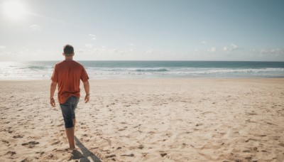 solo,short hair,shirt,black hair,1boy,short sleeves,male focus,outdoors,sky,barefoot,day,pants,cloud,water,from behind,shadow,ocean,beach,denim,t-shirt,red shirt,scenery,walking,jeans,sand,horizon,wide shot,shore,footprints,pants rolled up,shorts,blue sky,sun,facing away