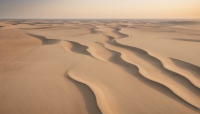 outdoors,sky,day,blue sky,no humans,shadow,beach,scenery,sand,horizon,shore,desert,solo,close-up,sunset,realistic