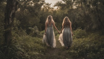 long hair,multiple girls,blonde hair,brown hair,dress,2girls,bare shoulders,outdoors,barefoot,from behind,white dress,bracelet,tree,holding hands,wavy hair,sunlight,grass,nature,scenery,forest,walking,siblings,rock