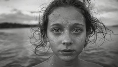 1girl,solo,looking at viewer,short hair,closed mouth,monochrome,greyscale,outdoors,water,blurry,lips,floating hair,depth of field,blurry background,ocean,beach,wind,messy hair,portrait,freckles,realistic,nose,straight-on,parted lips,sky,cloud,cloudy sky,horizon,dirty