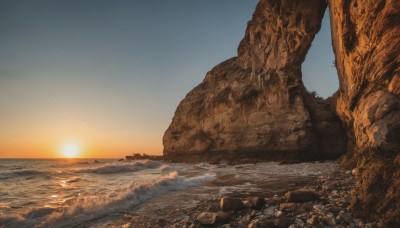 outdoors,sky,cloud,water,no humans,ocean,beach,sunlight,scenery,sunset,rock,mountain,sand,sun,horizon,river,landscape,shore,orange sky,cliff,blue sky,gradient sky