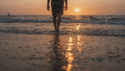 solo, 1boy, standing, male focus, outdoors, sky, shorts, barefoot, water, blurry, dutch angle, ocean, beach, scenery, wading, sunset, sand, sun, horizon, shore, footprints