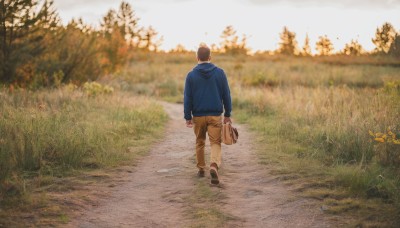 solo,short hair,brown hair,black hair,long sleeves,1boy,holding,standing,jacket,full body,flower,male focus,outdoors,shoes,day,pants,hood,bag,from behind,black footwear,blurry,tree,hoodie,hood down,grass,blue jacket,nature,scenery,forest,walking,arms at sides,facing away,road,holding bag,field,brown pants,wide shot,photo background,path,sky,blurry background,sneakers,sunset,realistic,blue hoodie