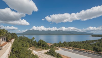 outdoors,sky,day,cloud,water,tree,blue sky,no humans,cloudy sky,grass,building,nature,scenery,forest,mountain,road,bush,house,street,river,landscape,path,hill,ocean,beach,ground vehicle,motor vehicle,horizon