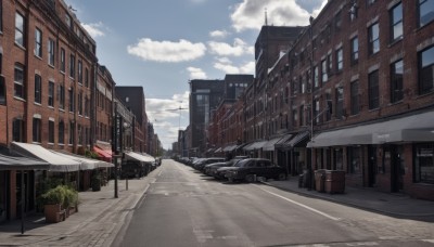 outdoors,sky,day,cloud,tree,blue sky,no humans,window,shadow,cloudy sky,plant,ground vehicle,building,scenery,motor vehicle,city,sign,car,potted plant,road,cityscape,house,power lines,lamppost,street,utility pole,crosswalk,truck,pavement