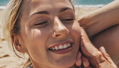 1girl,smile,open mouth,blonde hair,1boy,closed eyes,male focus,teeth,solo focus,blurry,lips,fingernails,blurry background,portrait,close-up,realistic,hand on another's face,hand on another's cheek,wrinkled skin,solo,outdoors,lying,day,beach,out of frame