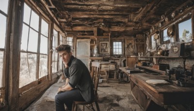 solo,looking at viewer,short hair,brown hair,shirt,black hair,1boy,sitting,jacket,male focus,day,pants,indoors,book,black shirt,window,facial hair,chair,black pants,table,scenery,desk,realistic,clock,lamp,photo (object),painting (object),tree,denim,snow,watch,jeans,candle,wooden chair