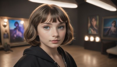 1girl,solo,looking at viewer,short hair,bangs,brown hair,brown eyes,jewelry,closed mouth,upper body,earrings,indoors,hood,blurry,lips,grey eyes,hoodie,depth of field,blurry background,hood down,zipper,freckles,realistic,nose,black hoodie,poster (object),eyelashes,bob cut,portrait,pink lips