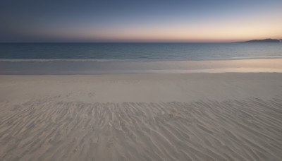 outdoors,sky,water,no humans,ocean,beach,scenery,sunset,sand,horizon,waves,shore,footprints,cloud,sun