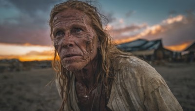 solo,long hair,looking at viewer,blue eyes,blonde hair,shirt,1boy,jewelry,closed mouth,upper body,male focus,outdoors,sky,cloud,necklace,blurry,wet,blurry background,facial hair,realistic,dirty,depth of field,cloudy sky,messy hair,portrait,beard,sunset,stubble