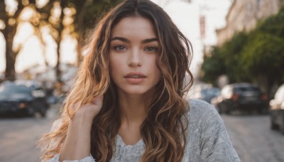 1girl,solo,long hair,looking at viewer,brown hair,shirt,black hair,brown eyes,white shirt,upper body,multicolored hair,outdoors,parted lips,blurry,lips,depth of field,blurry background,wavy hair,ground vehicle,motor vehicle,freckles,hand in own hair,realistic,nose,car,teeth,day,hand up,tree,eyelashes,thick eyebrows,blouse,portrait,road,photo background