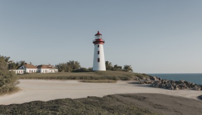 outdoors,sky,day,water,tree,blue sky,no humans,ocean,beach,grass,building,scenery,rock,sand,horizon,road,bush,river,tower,shore,path,real world location,lighthouse