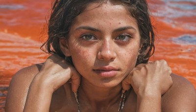 1girl,solo,long hair,looking at viewer,short hair,brown hair,black hair,brown eyes,jewelry,closed mouth,earrings,outdoors,dark skin,water,necklace,blurry,dark-skinned female,lips,hands up,blurry background,ocean,beach,portrait,close-up,freckles,sunset,realistic,nose,dirty,forehead