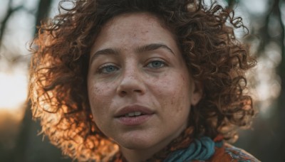 1girl,solo,looking at viewer,smile,blue eyes,brown hair,parted lips,teeth,blurry,tree,lips,depth of field,blurry background,messy hair,portrait,freckles,curly hair,realistic,nose,afro,jewelry,earrings,eyelashes,close-up,dirty