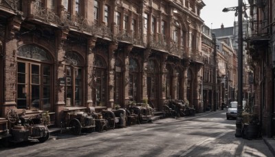 outdoors,sky,day,tree,no humans,window,sunlight,plant,ground vehicle,building,scenery,motor vehicle,city,sign,car,potted plant,road,lamppost,street,pavement,cloud,shadow,cityscape,architecture,motorcycle,vanishing point