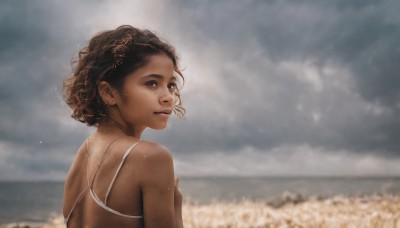 1girl,solo,looking at viewer,short hair,brown hair,black hair,bare shoulders,brown eyes,swimsuit,upper body,outdoors,sky,day,looking back,cloud,dark skin,from behind,blurry,dark-skinned female,lips,wet,blurry background,ocean,cloudy sky,freckles,curly hair,realistic,nose,spaghetti strap,field,very dark skin,hair ornament,jewelry,flower,sunlight,wind