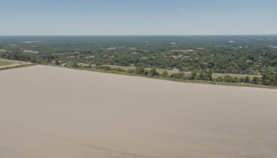 outdoors,sky,day,water,tree,blue sky,no humans,ocean,beach,building,nature,scenery,city,sand,horizon,road,cityscape,river,landscape,shore,hill,bird,ground vehicle,motor vehicle,forest,aircraft,vehicle focus