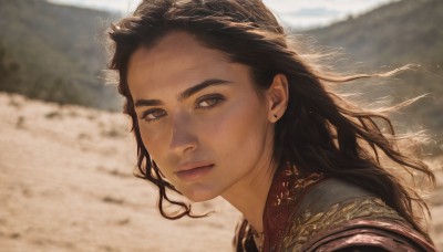 1girl,solo,long hair,looking at viewer,brown hair,black hair,brown eyes,jewelry,closed mouth,earrings,outdoors,day,armor,blurry,lips,depth of field,blurry background,portrait,freckles,realistic,nose,stud earrings,dark skin,dark-skinned female,wind,desert