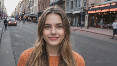 1girl,long hair,looking at viewer,smile,blonde hair,brown hair,shirt,closed mouth,upper body,outdoors,solo focus,day,pants,blurry,sweater,lips,grey eyes,depth of field,blurry background,ground vehicle,building,motor vehicle,freckles,city,realistic,car,road,orange shirt,street,photo background,real life insert,real world location,solo,blue eyes,portrait