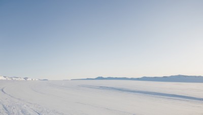 monochrome,outdoors,sky,day,blue sky,no humans,beach,scenery,mountain,sand,horizon,road,landscape,mountainous horizon,shore,desert,water,ocean,snow,blue theme,footprints