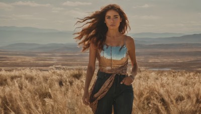 1girl,solo,long hair,looking at viewer,brown hair,shirt,bare shoulders,brown eyes,jewelry,closed mouth,standing,collarbone,cowboy shot,outdoors,sky,sleeveless,day,pants,cloud,dark skin,bracelet,dark-skinned female,lips,looking to the side,bare arms,floating hair,ocean,black pants,cloudy sky,denim,wind,scenery,camisole,hand in pocket,jeans,mountain,realistic,horizon,field,mountainous horizon,curly hair,spaghetti strap,landscape,wheat