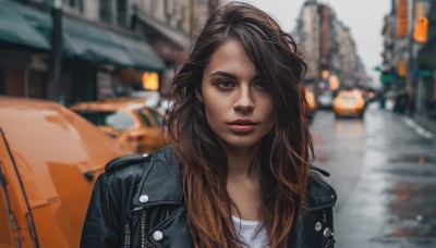 1girl,solo,long hair,looking at viewer,smile,brown hair,shirt,brown eyes,closed mouth,jacket,white shirt,upper body,multicolored hair,outdoors,open clothes,blurry,open jacket,lips,black jacket,makeup,depth of field,blurry background,denim,lipstick,ground vehicle,building,motor vehicle,freckles,realistic,red lips,car,leather,leather jacket,denim jacket,parted lips,thick eyebrows,city,road,street