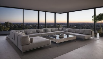 sky,cloud,indoors,water,tree,cup,pillow,no humans,window,ocean,chair,table,plant,building,scenery,couch,city,horizon,potted plant,cityscape,skyline,sunset,skyscraper