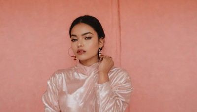 1girl,solo,looking at viewer,short hair,simple background,shirt,black hair,long sleeves,brown eyes,jewelry,white shirt,upper body,heart,earrings,parted lips,teeth,hand up,black eyes,lips,pink background,hoop earrings,realistic,sweater,makeup,ring,nose,white sweater