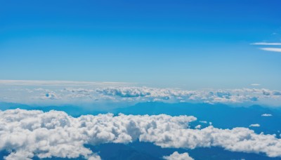 outdoors,sky,day,cloud,water,blue sky,no humans,bird,ocean,cloudy sky,scenery,flying,blue theme,horizon,landscape,above clouds,aircraft