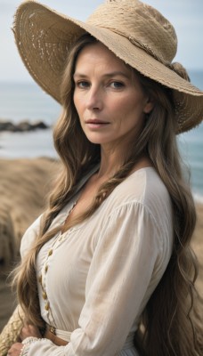 1girl,solo,long hair,breasts,looking at viewer,smile,blue eyes,brown hair,shirt,long sleeves,hat,dress,medium breasts,very long hair,closed mouth,upper body,outdoors,day,white dress,blurry,from side,lips,depth of field,blurry background,ocean,wavy hair,beach,freckles,sun hat,realistic,nose,brown headwear,straw hat,cleavage,brown eyes,jewelry,braid,earrings,sky,water,blouse