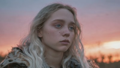 1girl,solo,long hair,blue eyes,blonde hair,closed mouth,jacket,white hair,outdoors,sky,mole,blurry,lips,looking to the side,fur trim,depth of field,blurry background,wavy hair,looking away,portrait,freckles,sunset,realistic,nose,looking afar,mole under eye