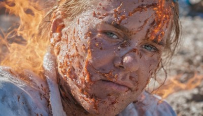 solo,looking at viewer,short hair,blue eyes,blonde hair,1boy,closed mouth,male focus,blurry,lips,blurry background,fire,portrait,realistic,burning,smile,green eyes,blood,depth of field,facial hair,close-up,injury,blood on face,dirty,dirty face