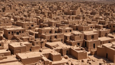 monochrome,outdoors,no humans,building,box,scenery,city,cityscape,sepia,brown theme,rock,sand,ruins,cardboard box