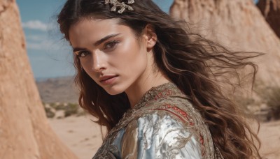 1girl,solo,long hair,looking at viewer,brown hair,black hair,hair ornament,brown eyes,jewelry,closed mouth,upper body,earrings,outdoors,wings,sky,day,blurry,from side,blue sky,lips,depth of field,blurry background,wavy hair,portrait,feathered wings,curly hair,realistic,nose,cloud,armor,desert,cliff