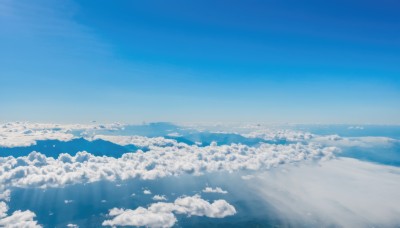 monochrome,outdoors,sky,day,cloud,water,blue sky,no humans,bird,ocean,beach,sunlight,cloudy sky,scenery,blue theme,mountain,horizon,landscape,above clouds