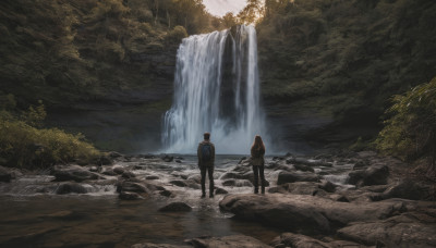 1girl, long hair, 1boy, standing, outdoors, water, from behind, tree, nature, scenery, forest, rock, waterfall