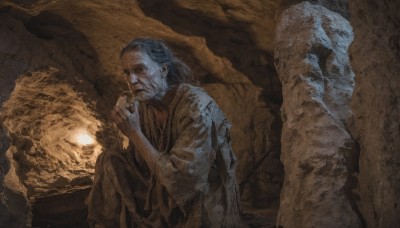 solo,long hair,blue eyes,long sleeves,1boy,holding,sitting,closed mouth,blue hair,grey hair,male focus,wide sleeves,from side,facial hair,own hands together,beard,robe,rock,old,old man,cliff,looking at viewer,pants,fire,smoke,cigarette,mustache,smoking