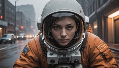 1girl,solo,looking at viewer,short hair,brown hair,black hair,brown eyes,closed mouth,jacket,upper body,outdoors,blurry,lips,depth of field,blurry background,helmet,ground vehicle,building,motor vehicle,reflection,rain,city,realistic,nose,car,road,street,spacesuit,space helmet,astronaut,portrait,freckles,science fiction,serious,dirty,american flag,grey sky