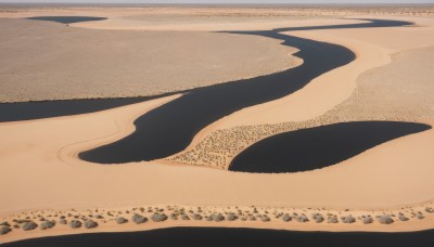 solo,outdoors,water,no humans,shadow,scenery,sand,desert,sky,day,beach,rock,silhouette,shore,footprints