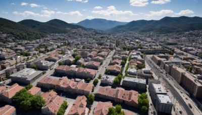 outdoors,sky,day,cloud,tree,blue sky,no humans,from above,building,nature,scenery,mountain,city,cityscape,landscape,cloudy sky,forest,house,mountainous horizon,real world location