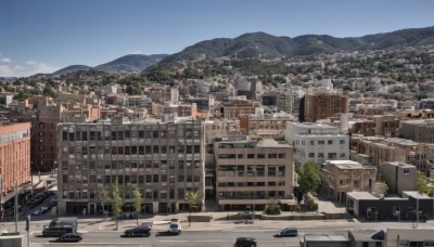 outdoors,sky,day,cloud,tree,blue sky,no humans,window,ground vehicle,building,scenery,motor vehicle,mountain,city,car,road,cityscape,street,skyscraper,landscape,truck,real world location,house,town